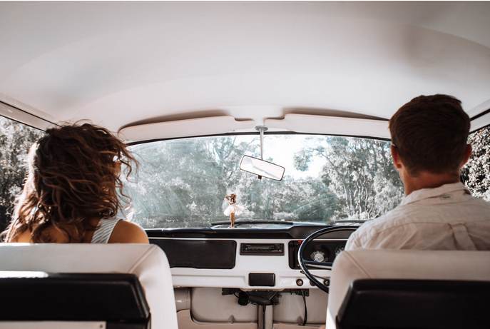 a man driving and a lady by the side